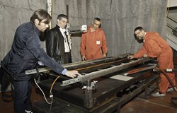 Preparing for the fire testing of a three-metre-long set of different cables. Pierre Cortes is second from left. (Click to view larger version...)
